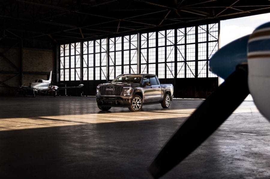 2027 GMC Sierra Denali Ultimate parked inside an aircraft hangar showcasing its premium design