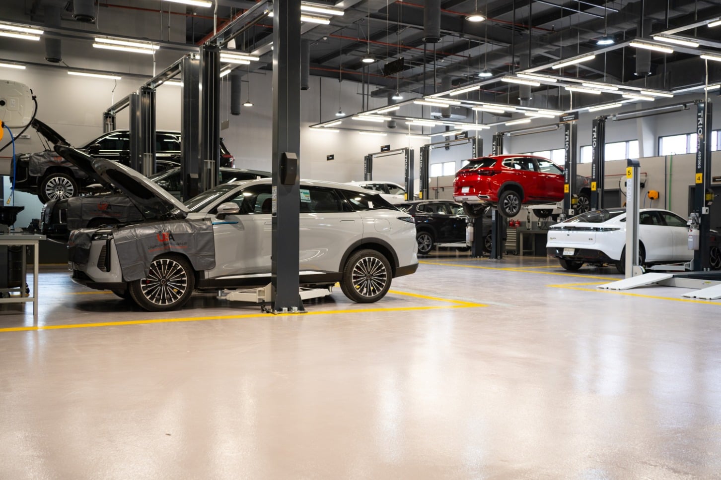 Automotive service workshop with multiple vehicles undergoing maintenance